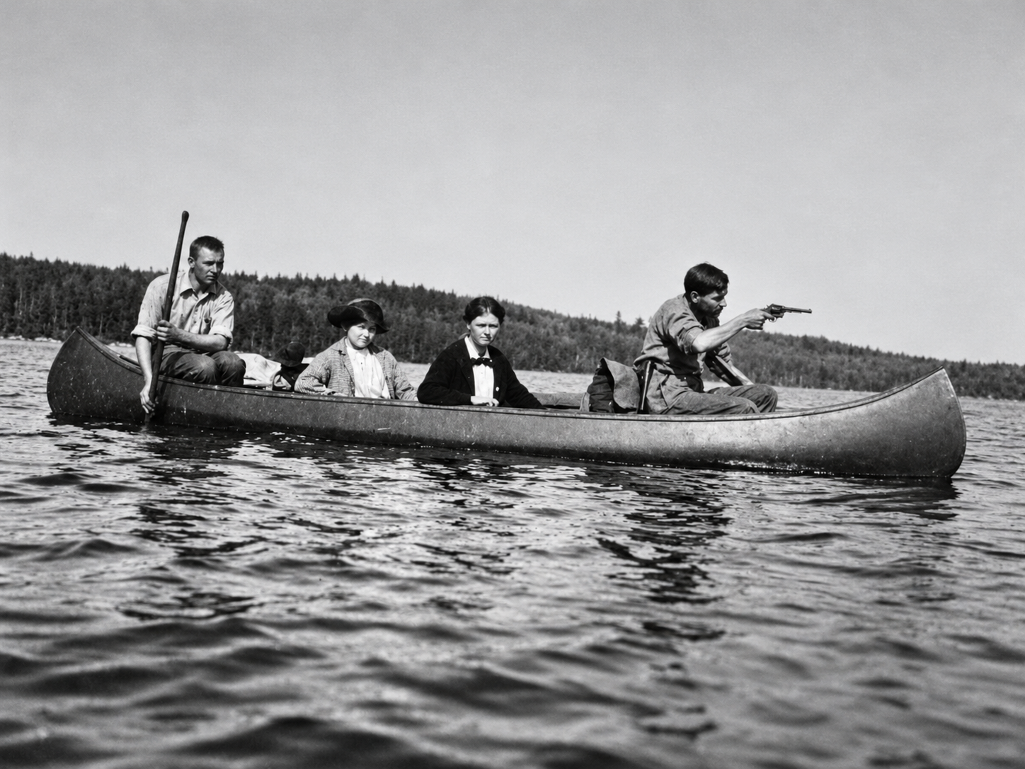 Four family members traveling by canoe on a lake, circa 1930s to 1940s.